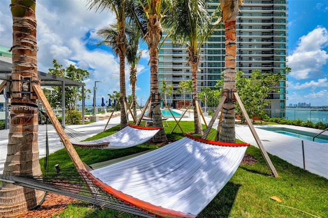 view of jungle gym featuring a community pool
