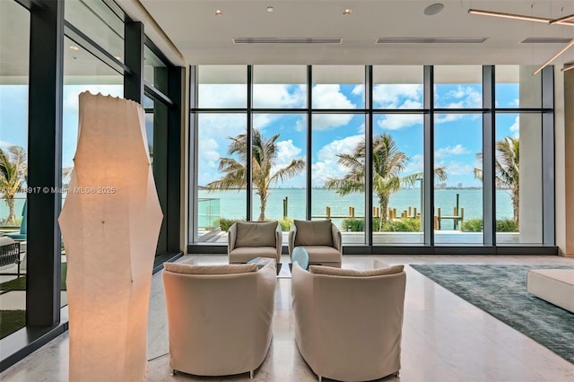 building lobby with visible vents and a water view