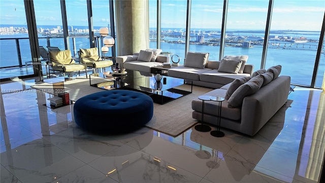 living room featuring marble finish floor, a view of city, and a water view