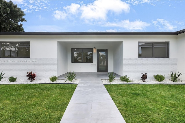 entrance to property with a yard