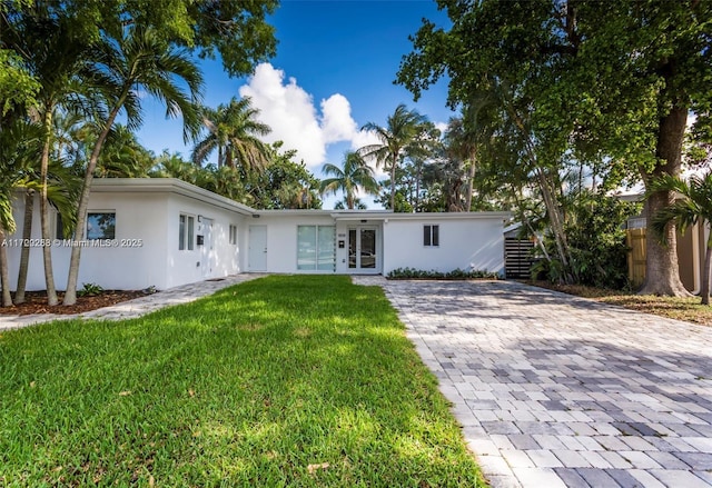 ranch-style house with french doors and a front lawn