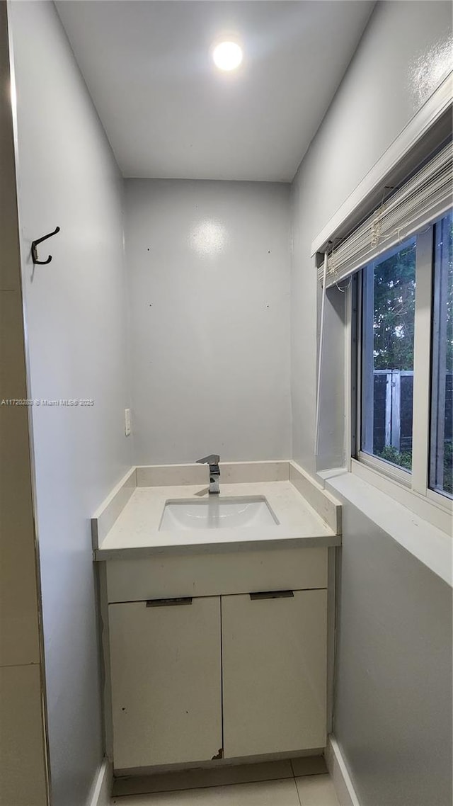 bathroom with tile patterned flooring and vanity