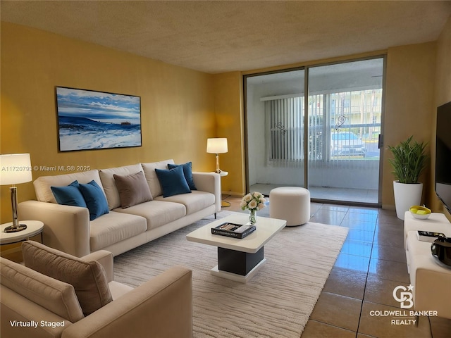 tiled living room featuring a textured ceiling