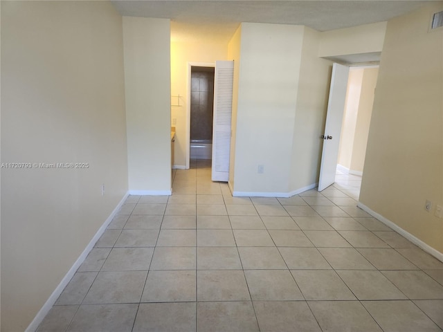 spare room featuring light tile patterned flooring