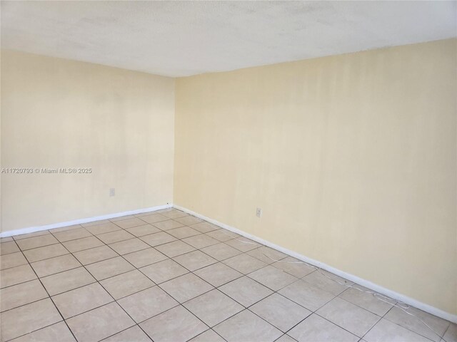 spare room with light tile patterned floors