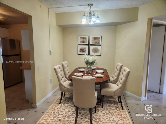 tiled dining room with a chandelier