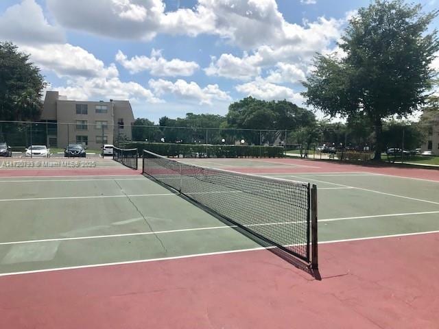 view of tennis court featuring basketball hoop