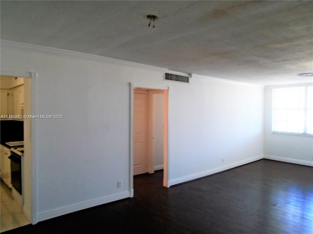 empty room featuring dark hardwood / wood-style floors and ornamental molding