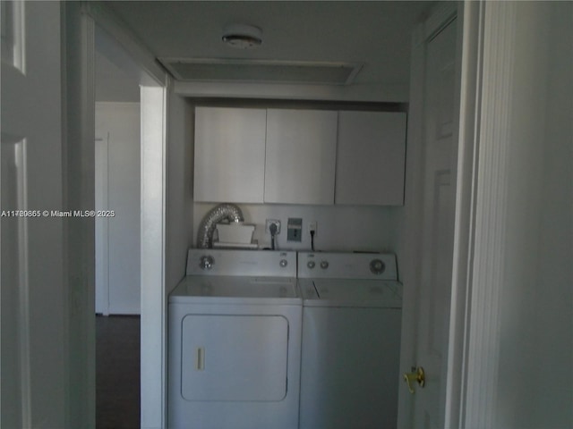 washroom with washer and clothes dryer and cabinets