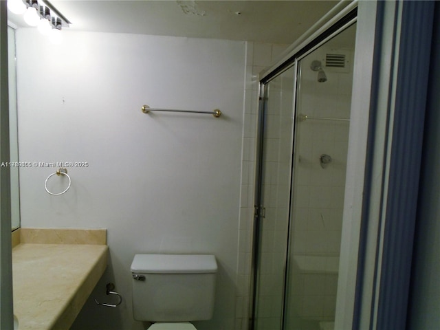 bathroom with vanity, toilet, and walk in shower