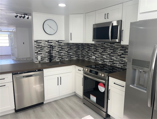 kitchen with white cabinets, stainless steel appliances, and sink