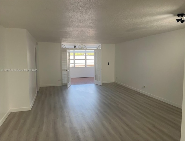 spare room with hardwood / wood-style flooring and a textured ceiling