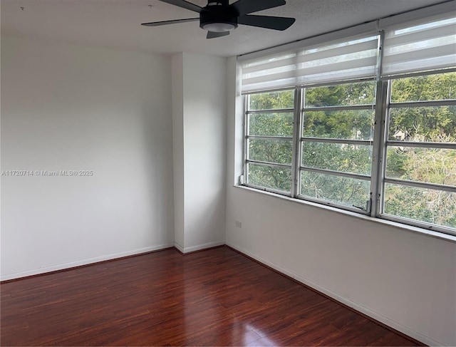 unfurnished room featuring ceiling fan and dark hardwood / wood-style flooring