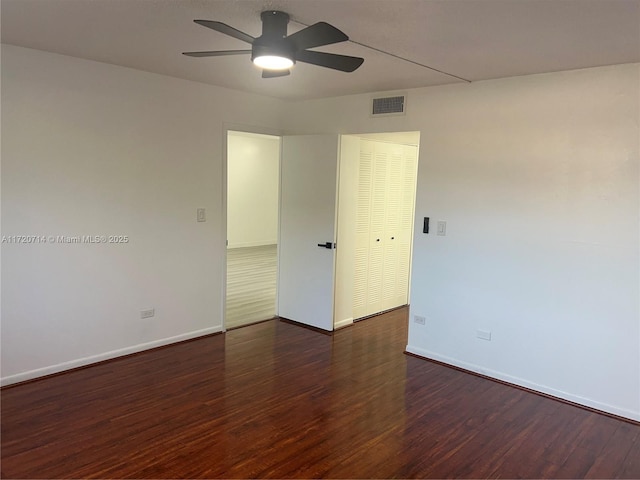 spare room featuring dark hardwood / wood-style floors and ceiling fan