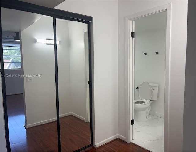 bathroom with wood-type flooring and toilet