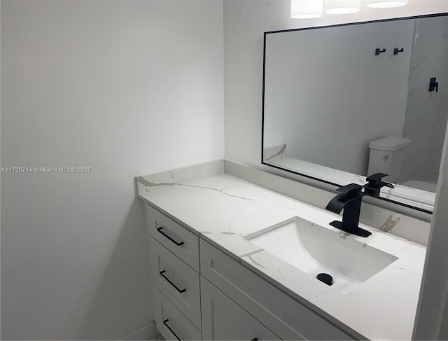 bathroom with vanity and toilet