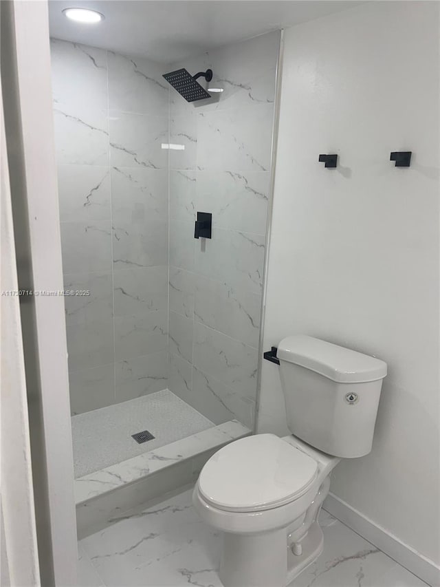 bathroom featuring toilet and tiled shower