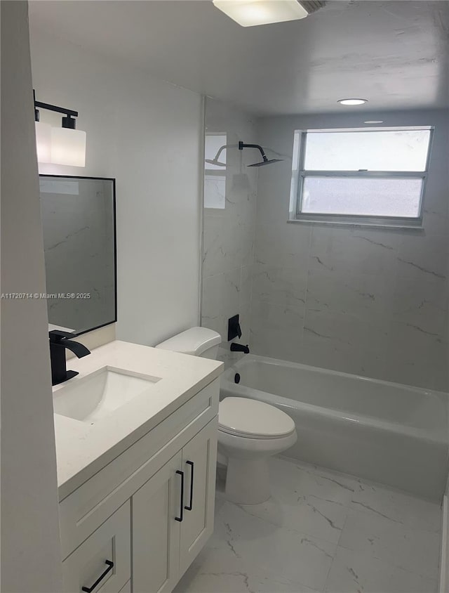 full bathroom with vanity, toilet, and tiled shower / bath