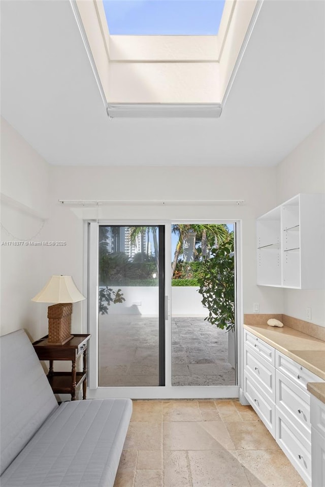 bedroom featuring access to exterior and a skylight