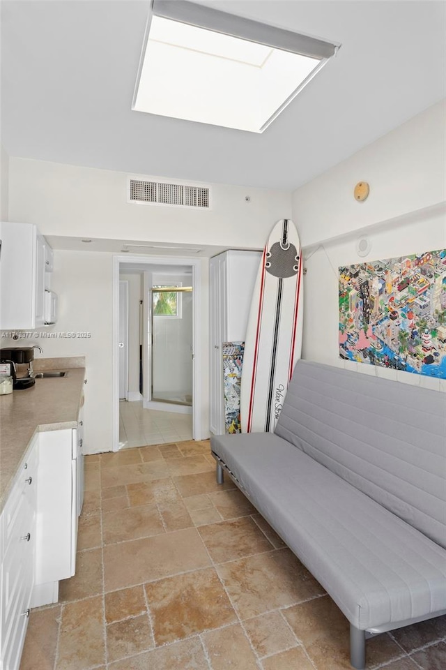 mudroom with a skylight and sink