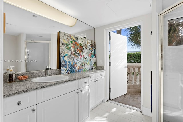 bathroom featuring vanity and a shower with door