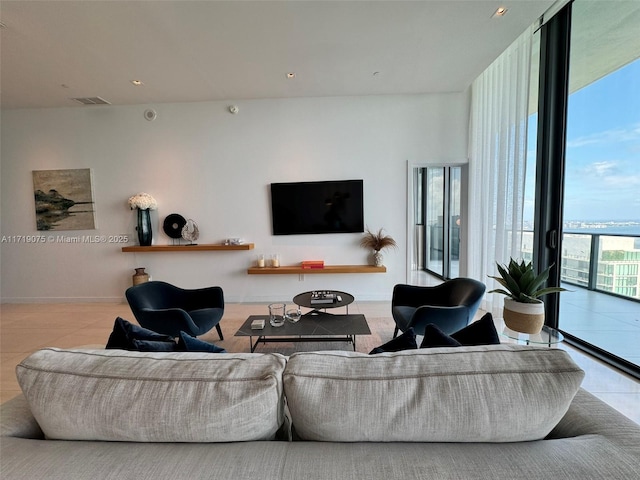 living room with floor to ceiling windows and a wealth of natural light