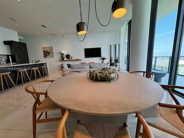 tiled dining room with expansive windows