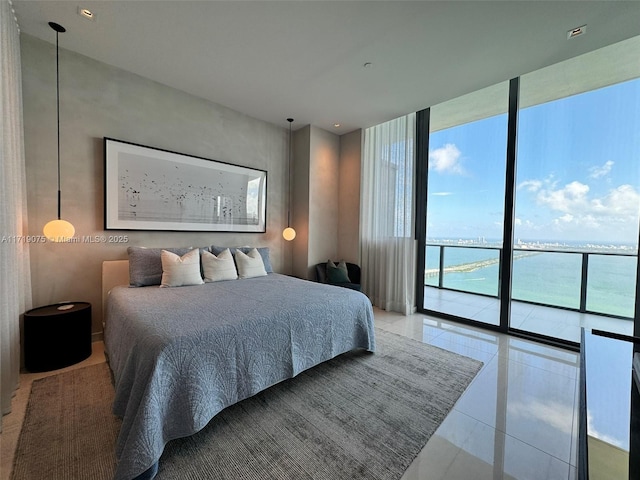 tiled bedroom featuring expansive windows, a water view, and access to exterior