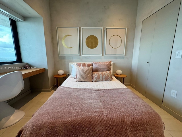 bedroom with light tile patterned floors