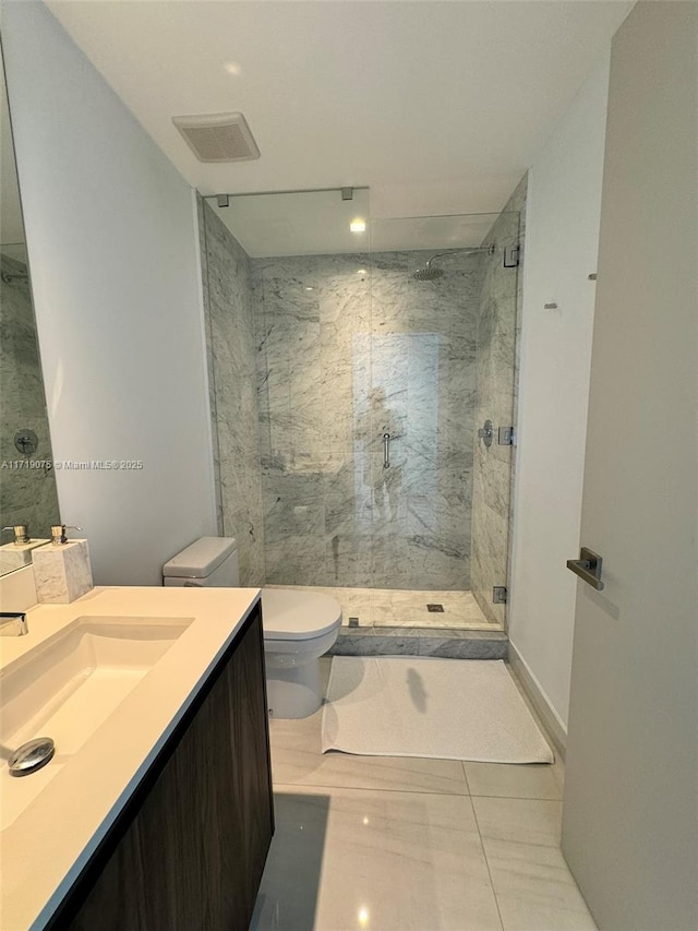 bathroom featuring tile patterned floors, vanity, an enclosed shower, and toilet