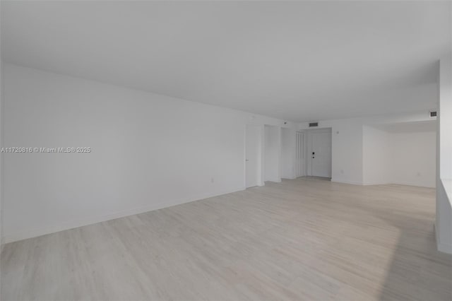 empty room with light hardwood / wood-style flooring