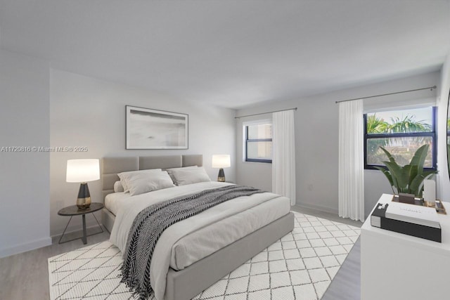 bedroom featuring light wood-type flooring and multiple windows