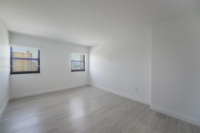 empty room featuring light hardwood / wood-style floors and a healthy amount of sunlight