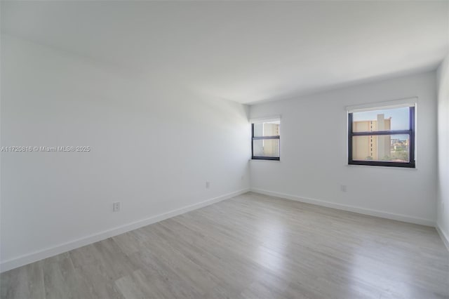 spare room featuring light hardwood / wood-style floors