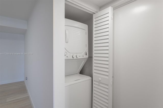 laundry area with stacked washer / dryer