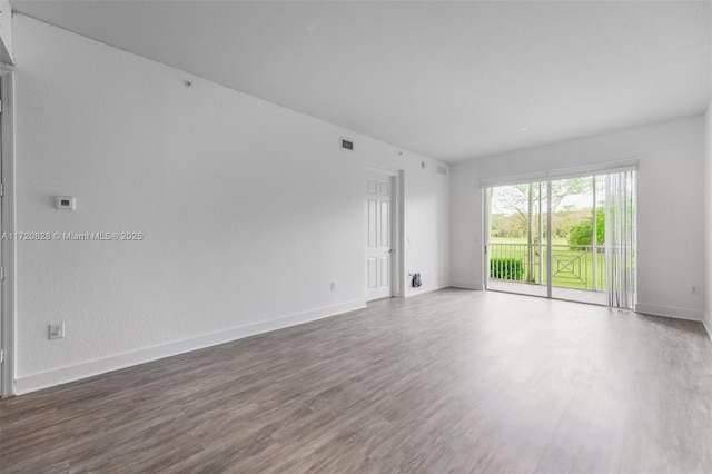 unfurnished room with hardwood / wood-style floors