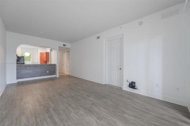 unfurnished living room with wood-type flooring