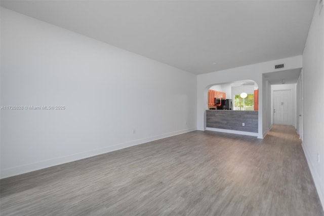 unfurnished living room with hardwood / wood-style floors