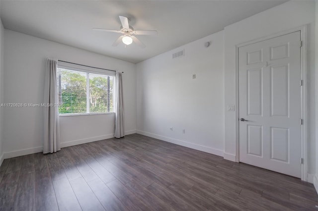 unfurnished room featuring ceiling fan and dark wood-type flooring