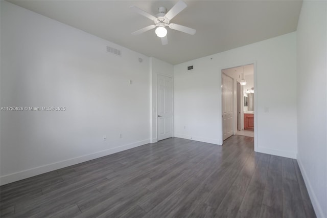 empty room with dark hardwood / wood-style floors and ceiling fan