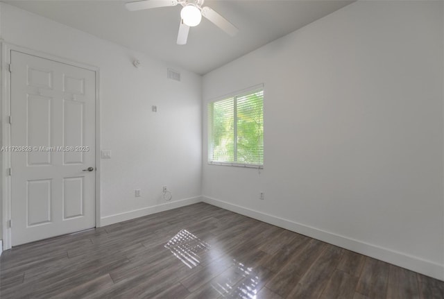 unfurnished room featuring dark hardwood / wood-style flooring and ceiling fan