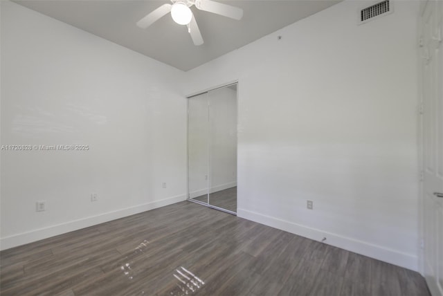 spare room featuring dark hardwood / wood-style floors and ceiling fan