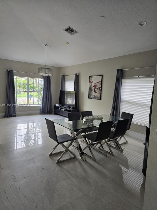 dining area with a notable chandelier