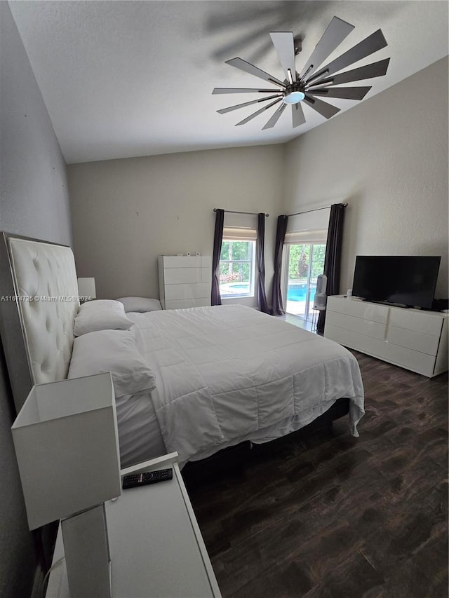 bedroom with ceiling fan, access to exterior, lofted ceiling, and wood-type flooring