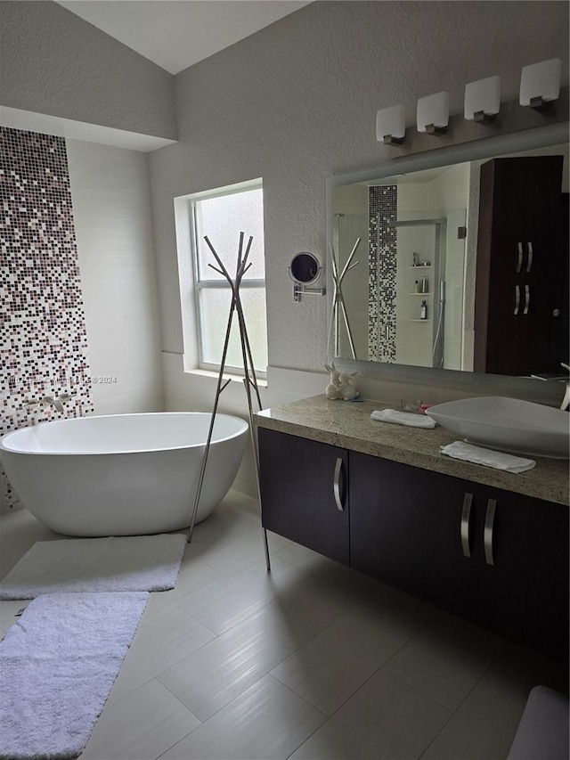 bathroom featuring tile patterned floors, vanity, and separate shower and tub