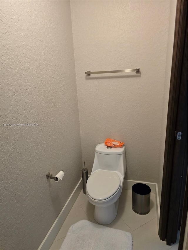 bathroom with tile patterned flooring and toilet