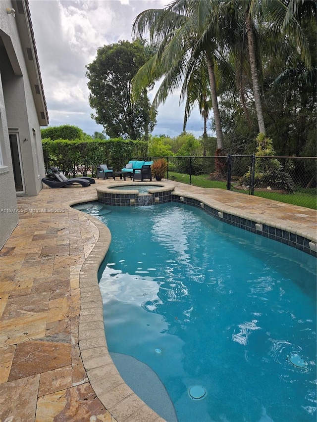 view of pool with a patio area and an in ground hot tub