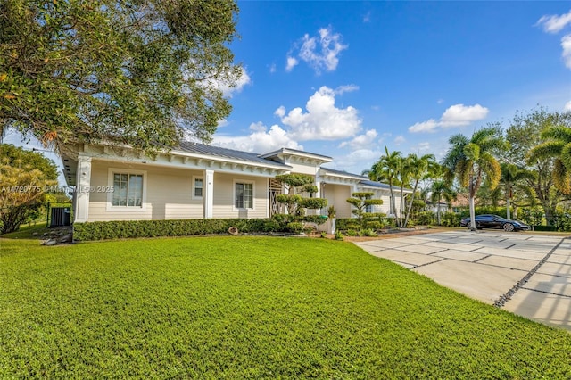 view of front of home with a front lawn and central AC unit