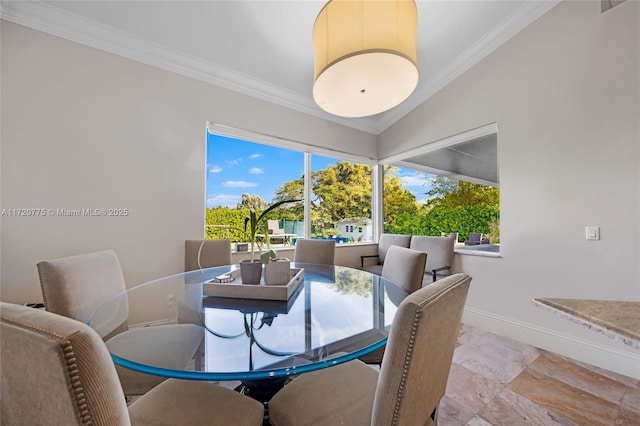 dining area with lofted ceiling and crown molding