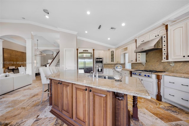 kitchen with a large island, lofted ceiling, stainless steel appliances, and range hood